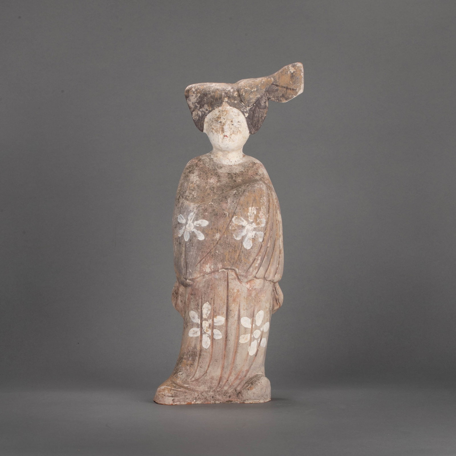 Tang Dynasty Colorful Beauty Figurine: This colorfully decorated beauty figurine from the Tang Dynasty is in the shape of a standing lady, with her hair in a high bun, a round face, a plump and graceful body. It is a typical portrayal of t