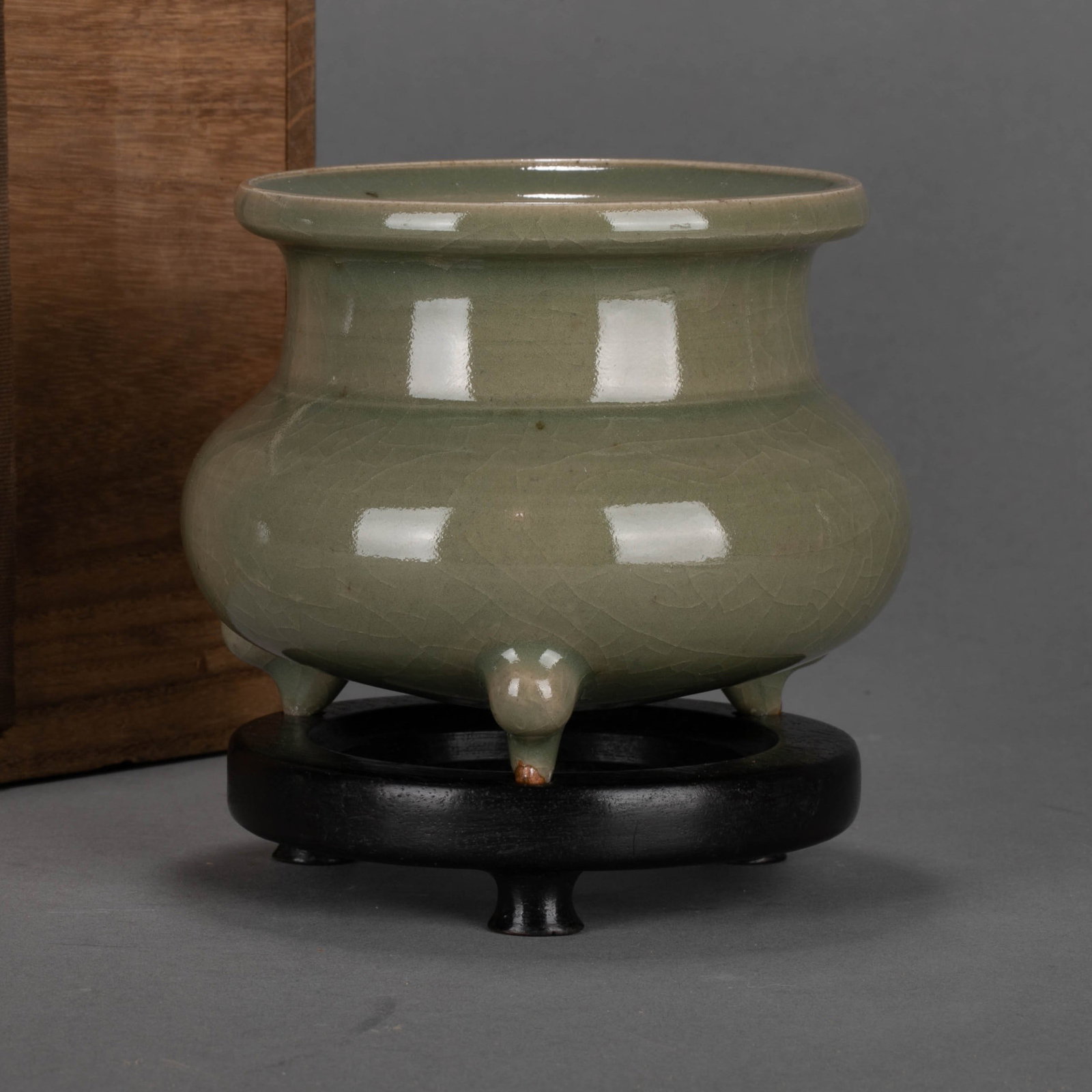 Song Celadon three-legged Incense Burner: This celadon three-legged Incense Burner from the Song Dynasty is shaped like a lip, a girdle neck, a bulging belly, and three Ruyi feet below. It is well-proportioned, dignified and elegant. It is a