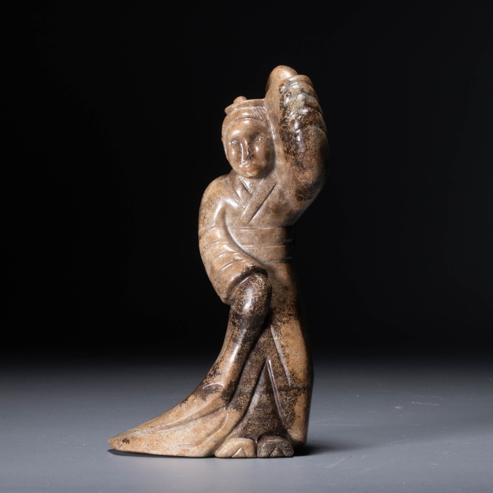 Han Jade Dancer: This jade dancer from the Han Dynasty is in the shape of standing sideways, with long sleeves stretched out, one arm raised above the head, and one arm hanging down. The clothes are flowing, which viv