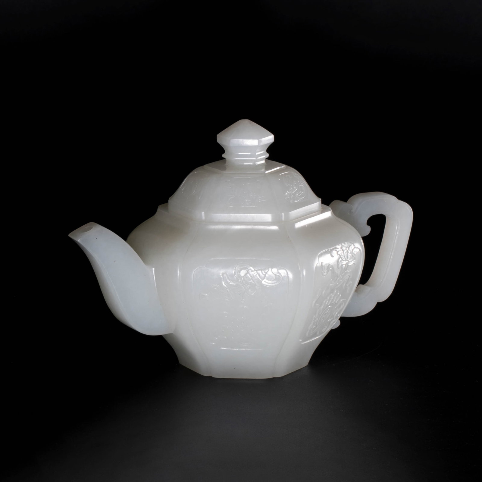 Qianlong period of the Qing Dynasty, a white jade six-sided teapot: This is a white jade six-sided teapot from the Qianlong period of the Qing Dynasty. Its style is the jade craftsmanship of the Qing Dynasty.The body of the pot is in a regular hexagonal shape and is