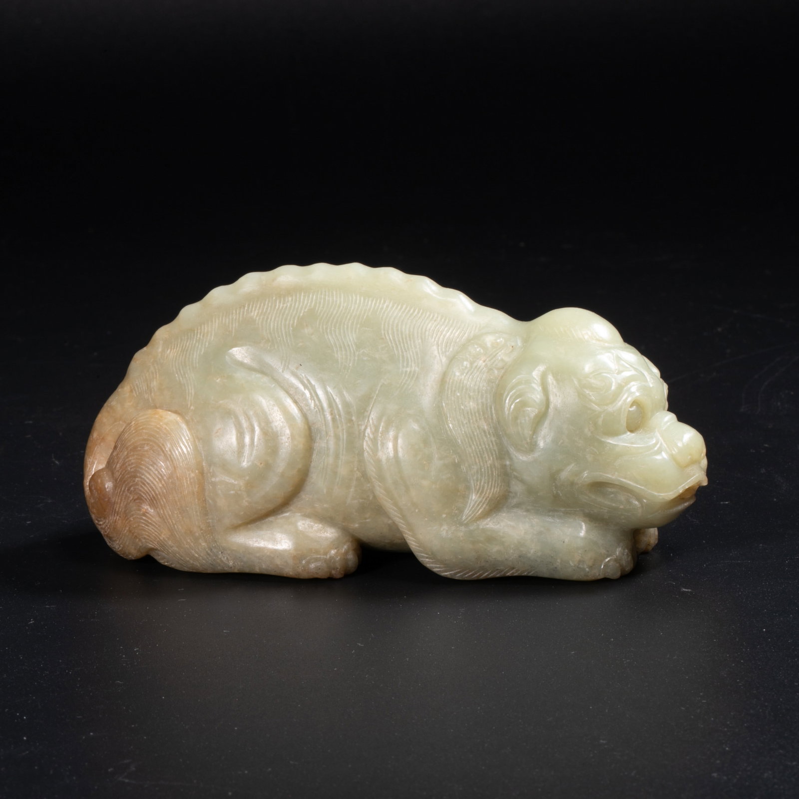 Qing Dynasty Hetian green and white jade auspicious beast: This is a Hetian green and white jade carving of auspicious animals from the Qing Dynasty.The jade is warm and delicate, bluish-white in color, with natural yellowish-brown color in parts, simple and 