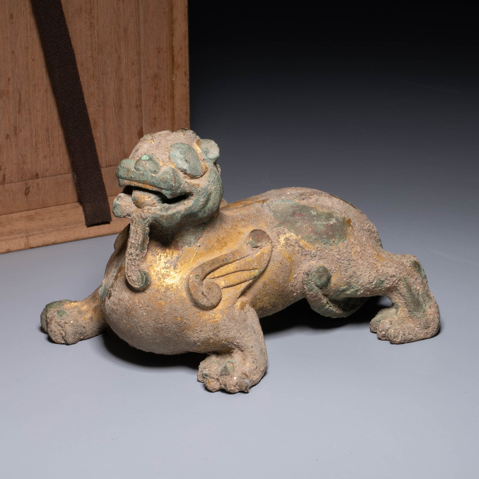 Han dynasty gilt bronze to ward off evil spirits: This is a gilt copper ward off evil spirits (or Tianlu) charm/ornament.The mythical beast is lying down and gaining momentum, with its head raised and its face ferocious. The sides of its body are