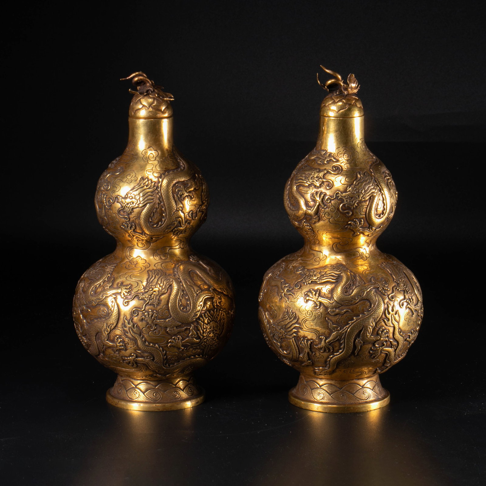A pair of gilt-bronze gourd vases with floating dragon pattern, Qianlong period, Qing Dynasty: A pair of gilt-bronze gourd vases with floating dragon pattern, Qianlong period, Qing Dynasty