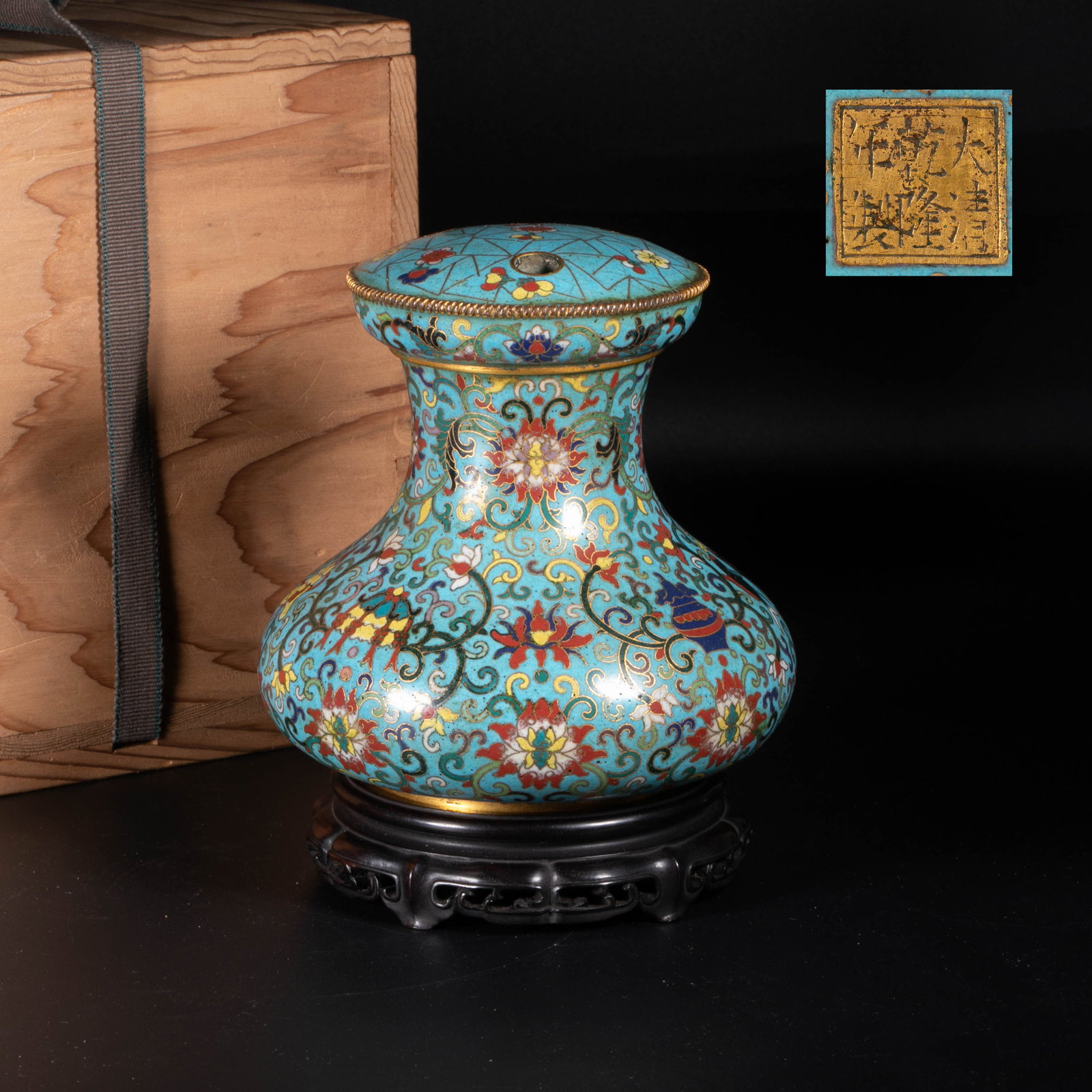 Qianlong Period, Qing Dynasty: This is a cloisonne enamel three-hole flower arrangement with eight auspicious branches and lotus patterns from the Qianlong period of the Qing Dynasty. It is a typical display device of the cloisonne
