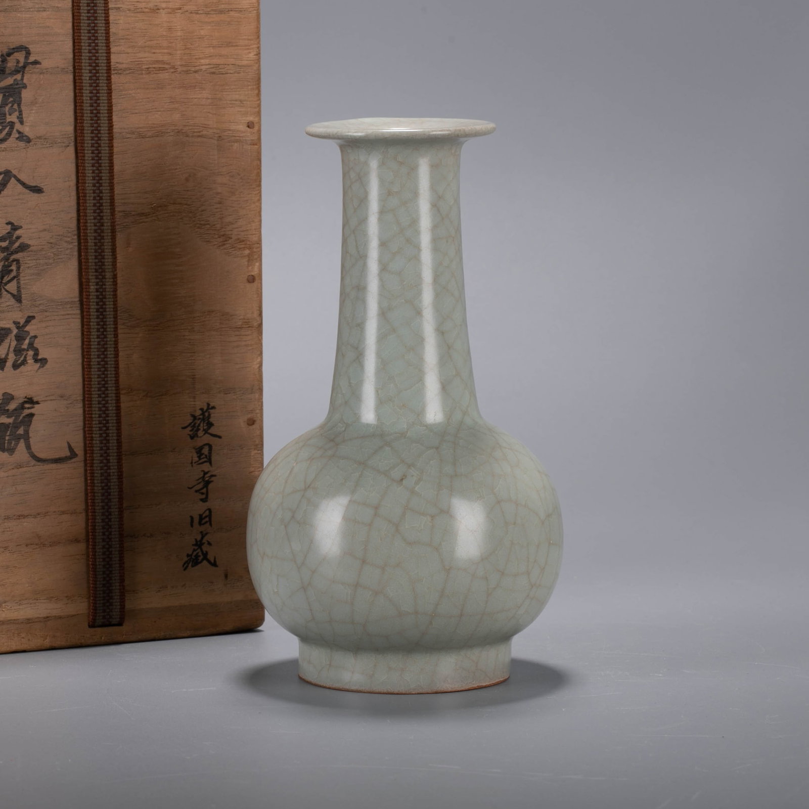 Longquan celadon vase: This piece is Longquan celadon / Ge ware meaning (open piece celadon) long neck vase, and the wooden box is inscribed "Penetration celadon vase / Former Collection of Huguo Temple" ("Penetration" mean