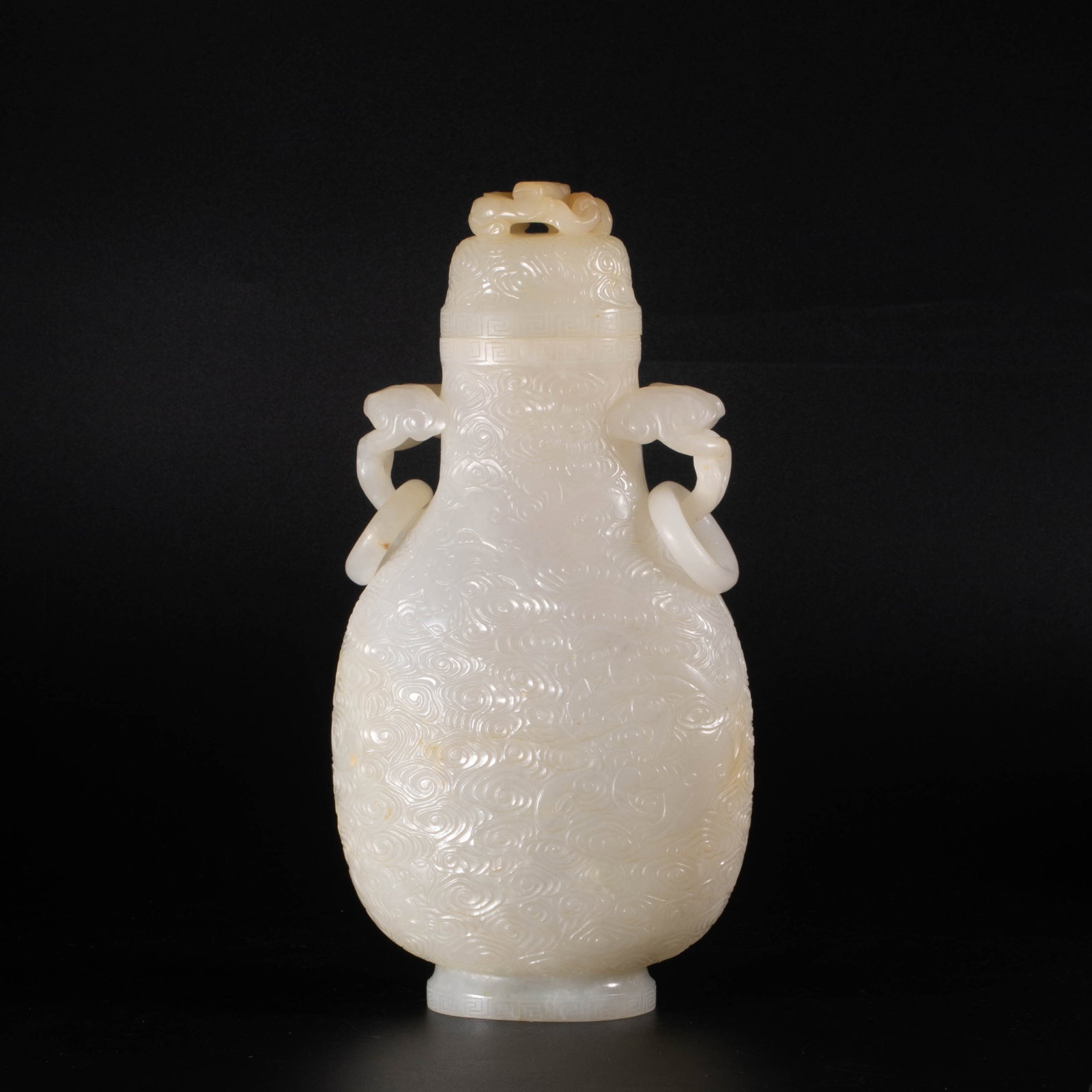 Qing Dynasty white jade vase with dragon motif: This Qing style white jade dragon motif vase is made from the whole material white jade. The texture is like gelatin, warm and translucent, with a slight natural warmth. The vessel is made of vase sty