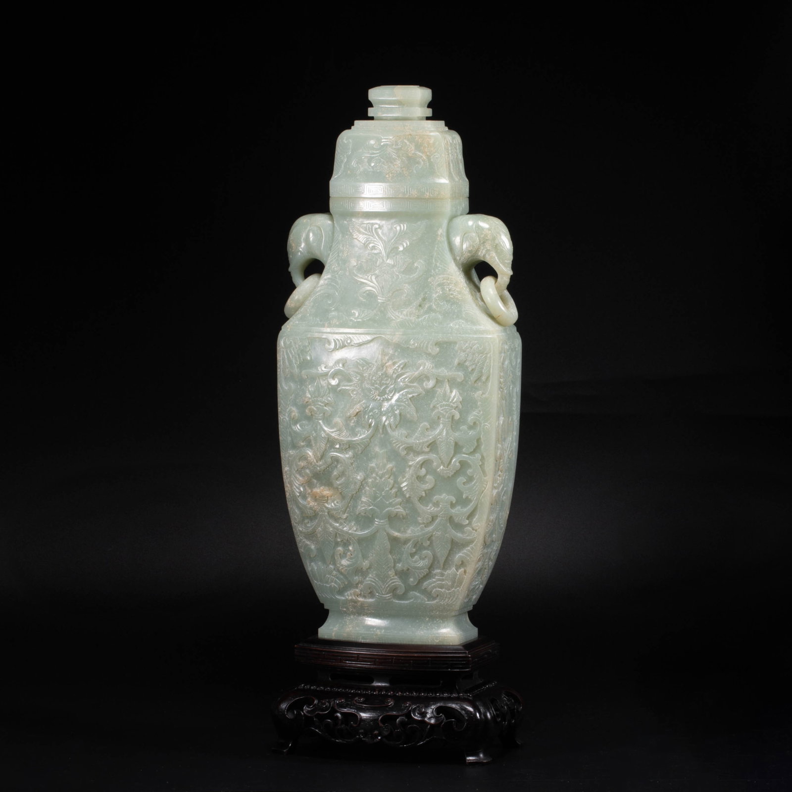 Qing Flower Double elephant-head handles large vase: This Qing style green white jade flower double elephant-head handles large vase, the jade quality is clear and moist, light green, warm and shiny. The shape of the vessel is straight and straight,