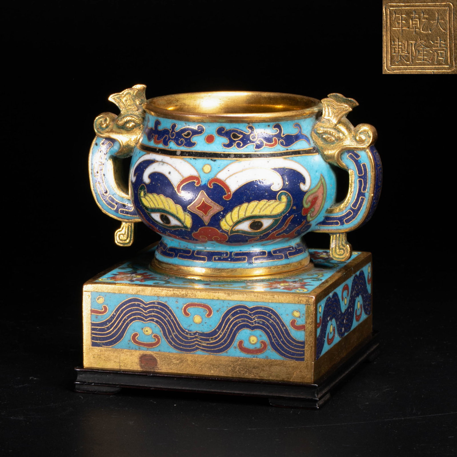 Qianlong Period, Qing Dynasty, cloisonne enamel gui ritual food vessel style incense burner with: This piece is Qianlong style cloisonne enamel gui ritual food vessel style incense burner of the Qing dynasty, with a rosewood pedestal. The shape of the vessel is based on the Shang and Zhou bronze g
