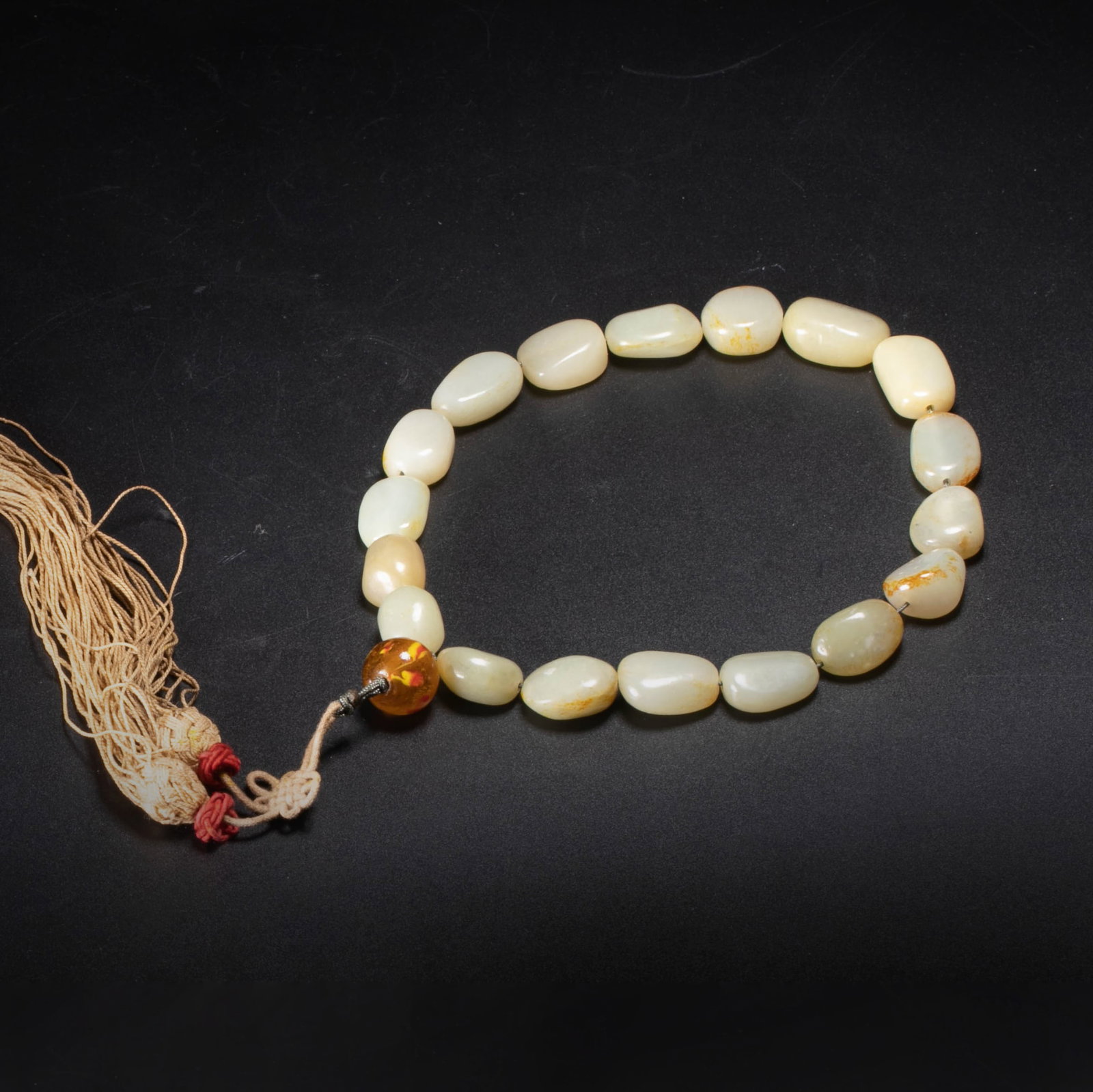 Qing Hetian jade Shibazi: This item is marked as Qing dynasty Hetian jade Eighteen Zi Bracelet/Twisted Beads, made of eighteen oval jade grains in random shapes. The color is warm white to bluish white, with a yellowish-brown