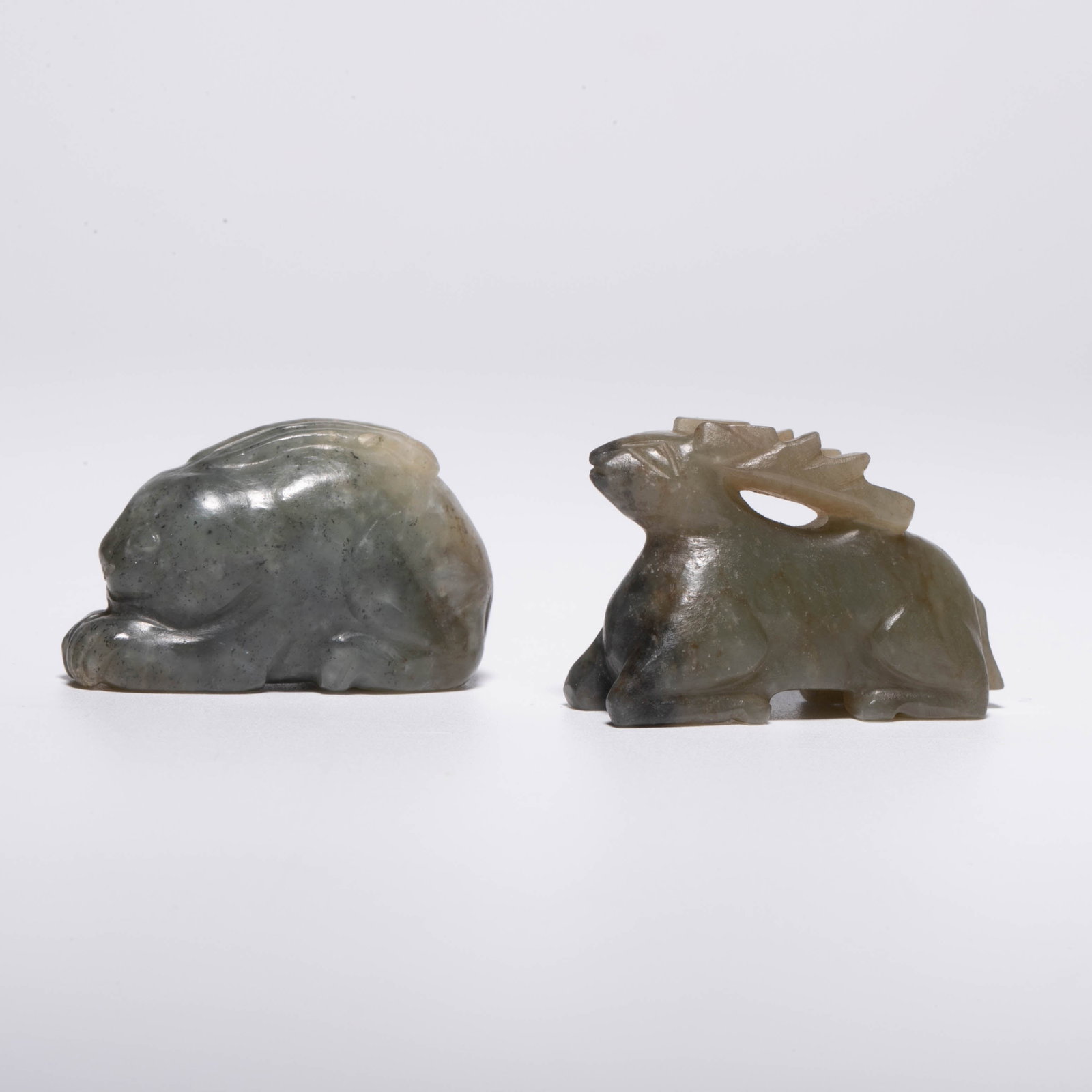 Song Dynasty pair of jade rabbit and deer: This pair is a Song dynasty style green-grey/blue and white small jade piece, one is a lying rabbit, and the other is a lying deer (the antlers are hollowed out openwork carved, the body is lying