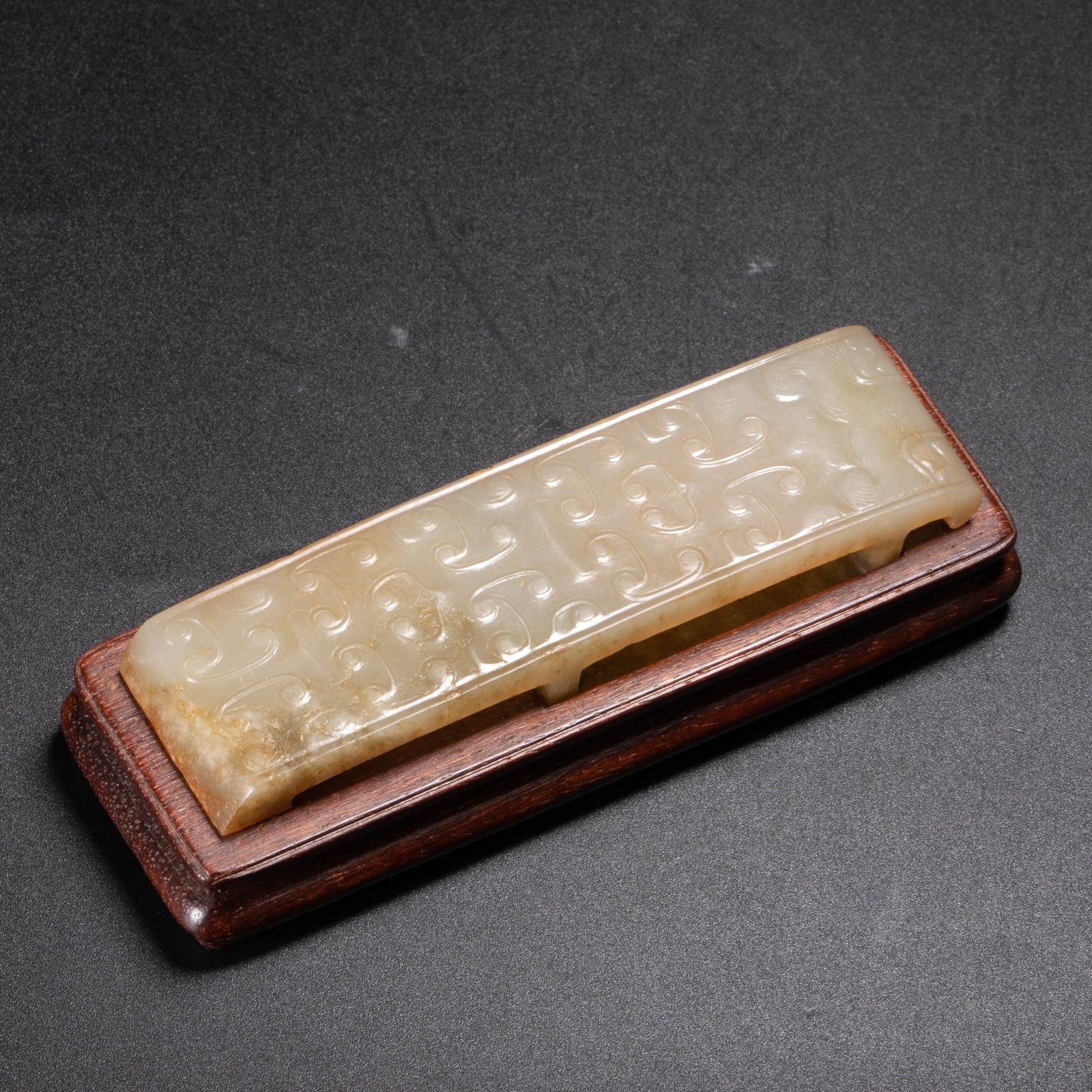 Han Dynasty sword chape: This sword chape is carved in the style of Han dynasty jade sword fittings and may represent a later archaistic reproduction or a subsequently modified piece intended for use as a small scholar's
