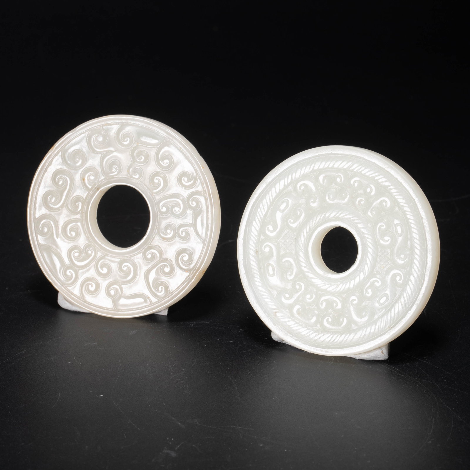 Carved jade pendant with floral motif and jade bi disc with grain motif: Carved jade pendant with floral motif and jade bi disc with grain motif