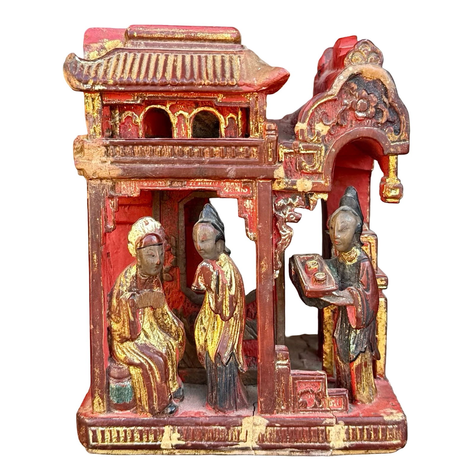 Chinese Gilt-Lacquered Wan Carving: Antique hand-carved wood sculpture of figures within a pavilion or temple. The base features a swastika motif, known in Chinese as wàn (?). Finished with red lacquer and gold gilt accents. Likely