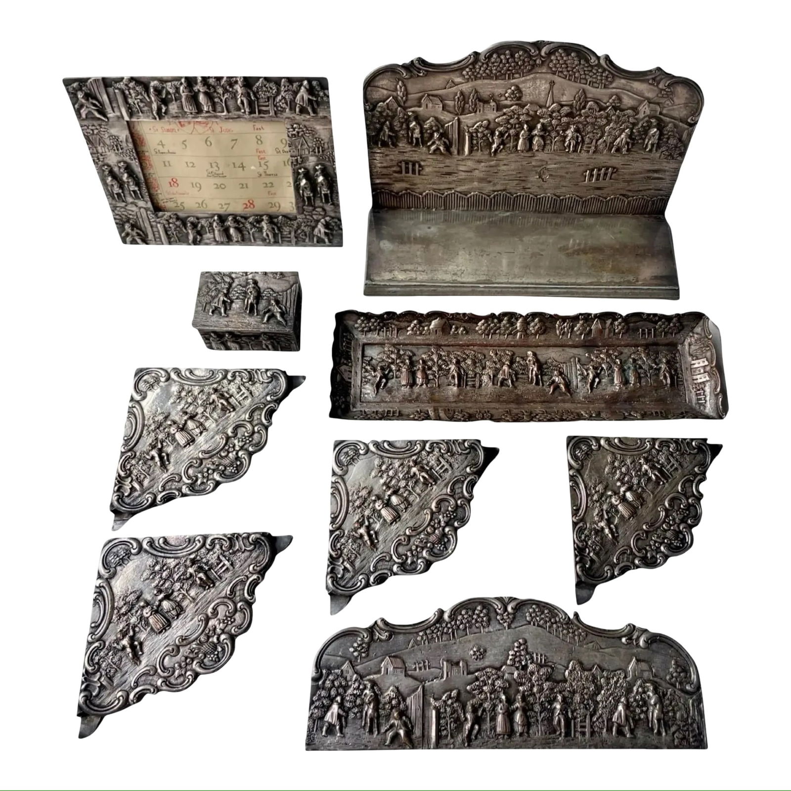 E.G. Webster Silverplate Desk Set 9pc: Antique E.G. Webster & Sons silver-plated 9-piece desk set, featuring high relief decoration including letter holder, blotter accessories, tray, box, and frame with 1948 calendar inserts.