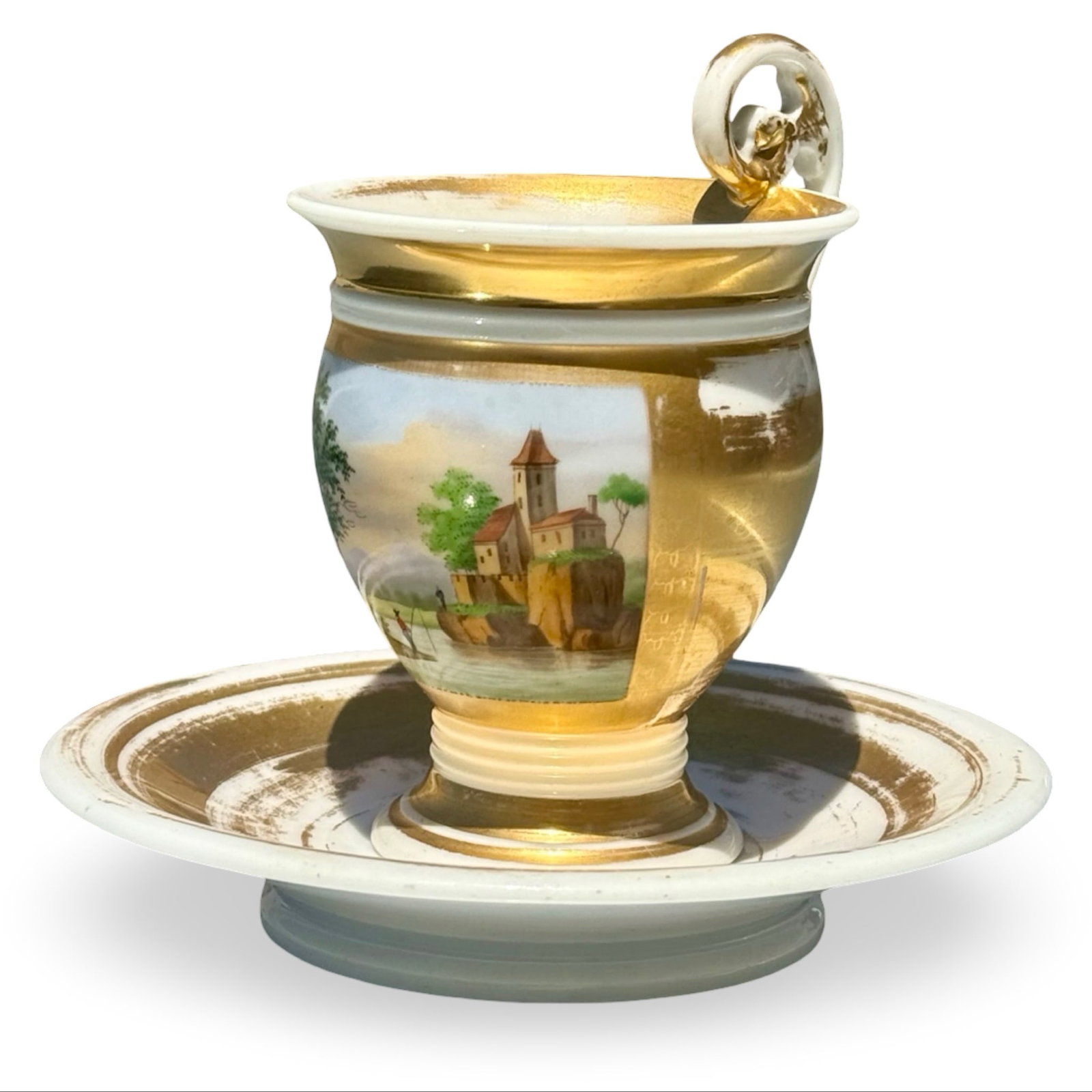 Biedermeier Topographical Cup Saucer: Biedermeier style Empire period cup and saucer with hand-painted topographical landscape scene and gilt accents. Approx. Dimensions: Saucer measures 5.25W x 5.25D x 1H inches and cup measures 4.25H x 