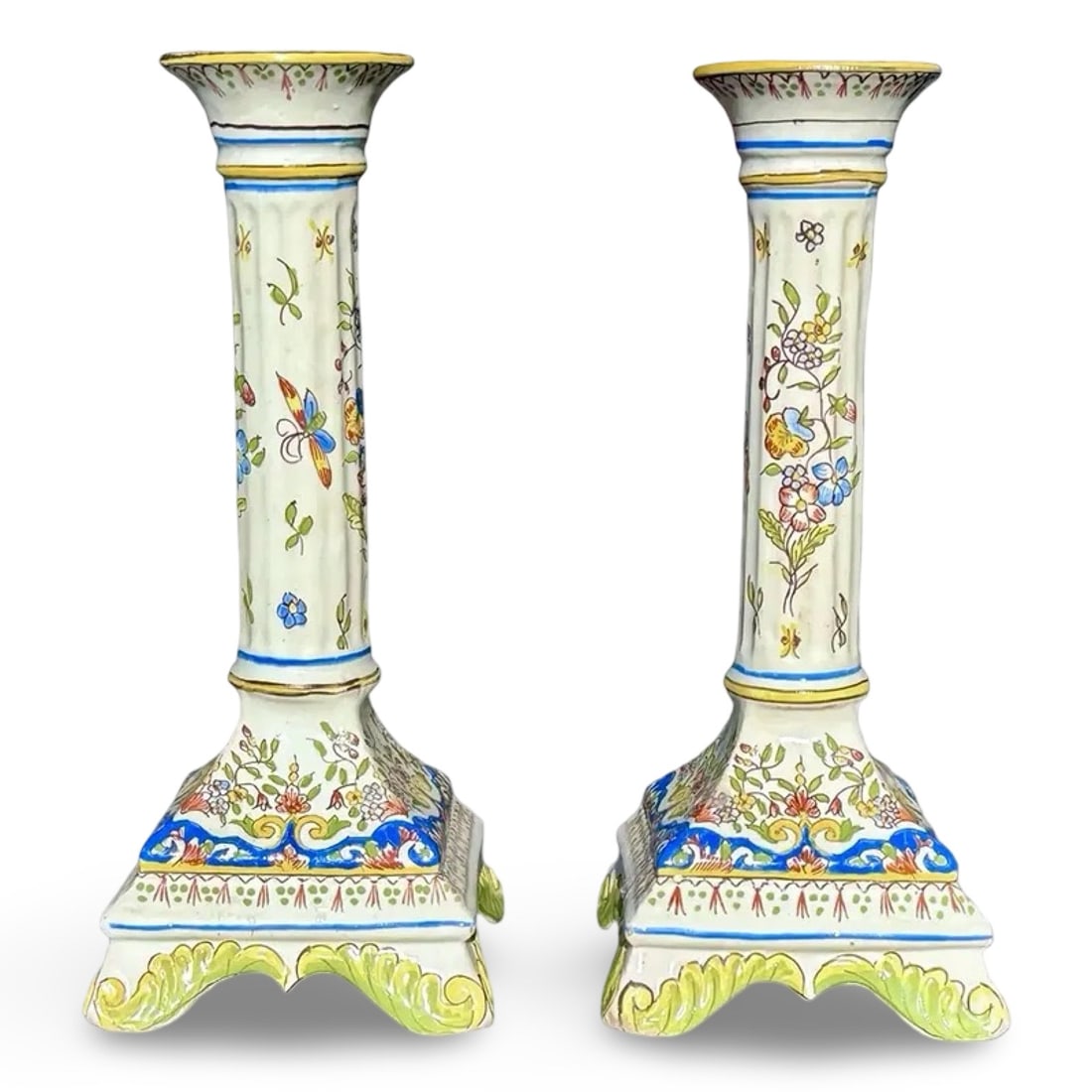 Pair French Desvres Faience Candlesticks: Pair French Desvres Faience Candlesticks Pair of antique French faience candlesticks featuring hand-painted polychrome Rouen-style decoration on glazed earthenware with fluted stems, scrolled feet,