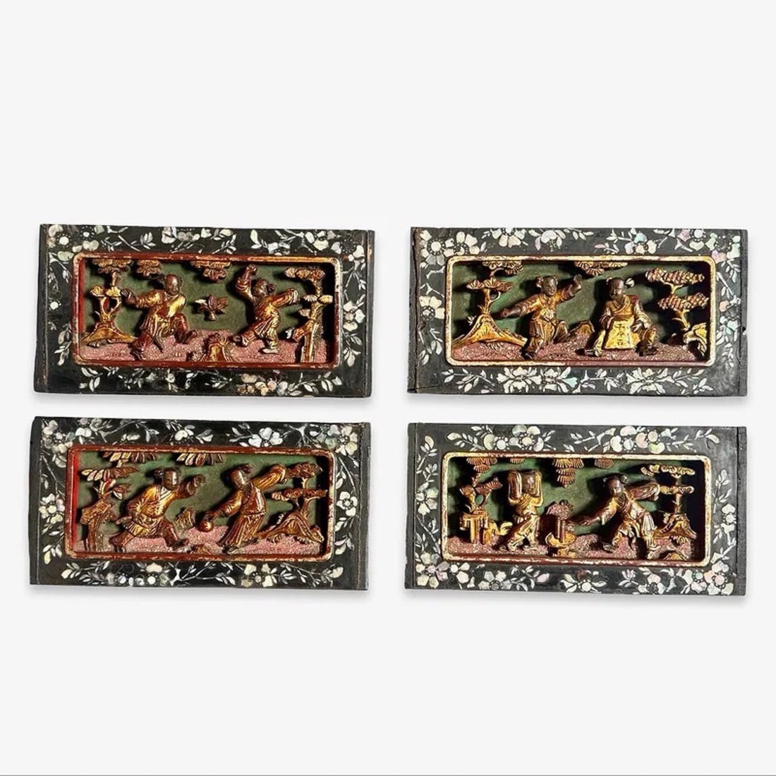 Chinese MOP Carved Gilt Wood Plaques Set 4: Set of four Chinese lacquered wood plaques with mother of pearl inlay, high-relief figural carvings, and gilt accents. Attributed to late Qing period. Approx. Dimensions: 4.5H x 8.5W × .75D inches