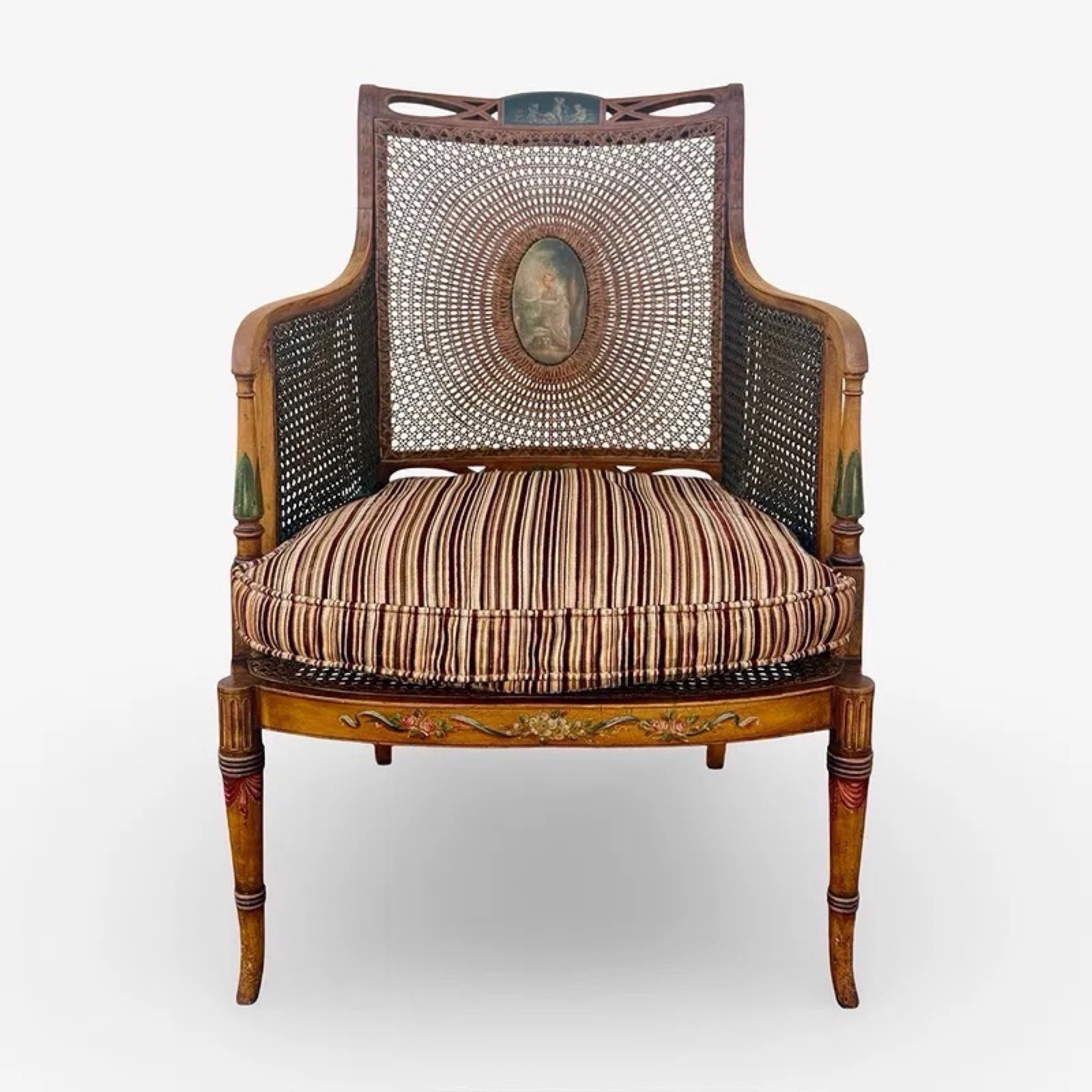 English Regency Cane Bergere Library Armchair: Antique satinwood Sheraton Revival bergere caned library armchair with painted Neoclassical details and wide seat. Includes removable cushion. No reserve. Approx. Dimensions: 40H x 27W x 22D inches