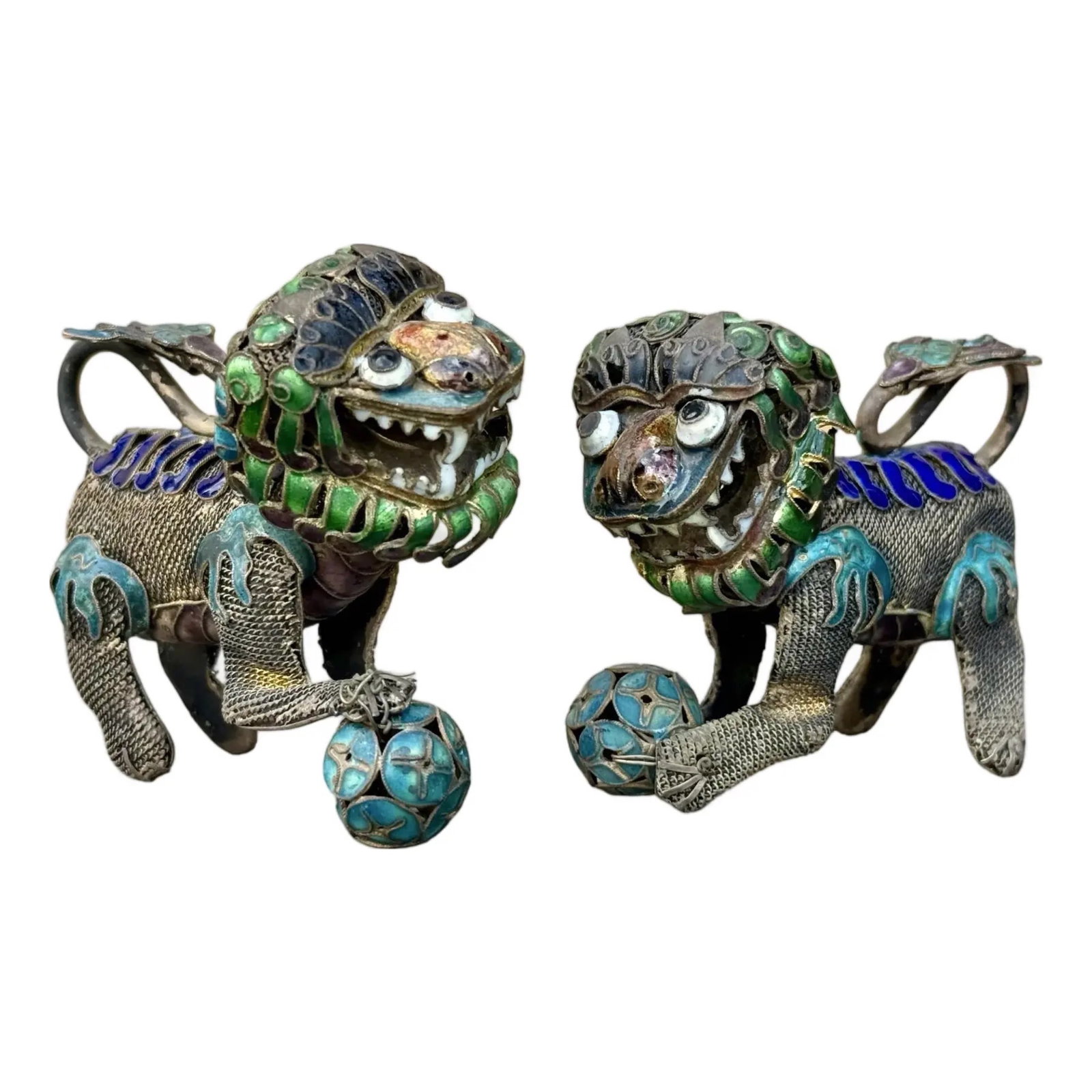 Chinese Enamel Foo Dog Pair: Chinese enamel Foo Dogs guardian lions pair with cloisonné-style filigree. Heads rotate. Approx. Dimensions: 2.5H x 1.5W x 3D inches