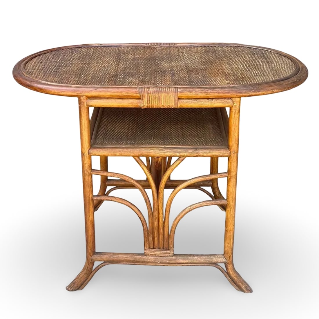 Art Deco Palm Rattan Table: Art Deco Palm Rattan Table with flared, fan-like Palm decoration on the base, supporting an oval top. Dimensions: 29H x 38.5W x 20.5D inches