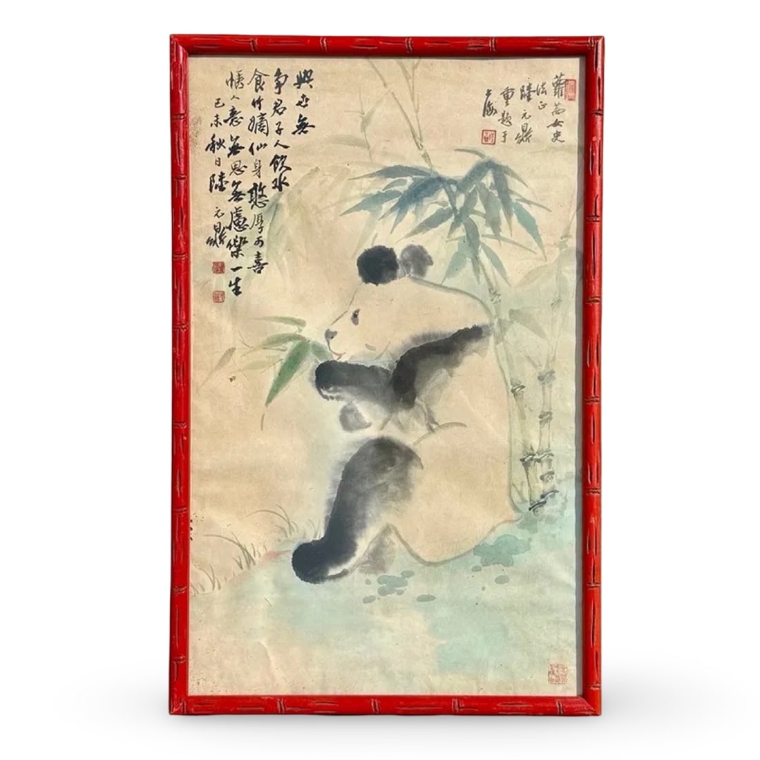 Chinese Panda Watercolor Painting: Watercolor painitng of a panda eating bamboo in the style of Wu Zoren, set in a red faux-bamboo frame. Dimensions: 27H x 17W x 1.5D inches