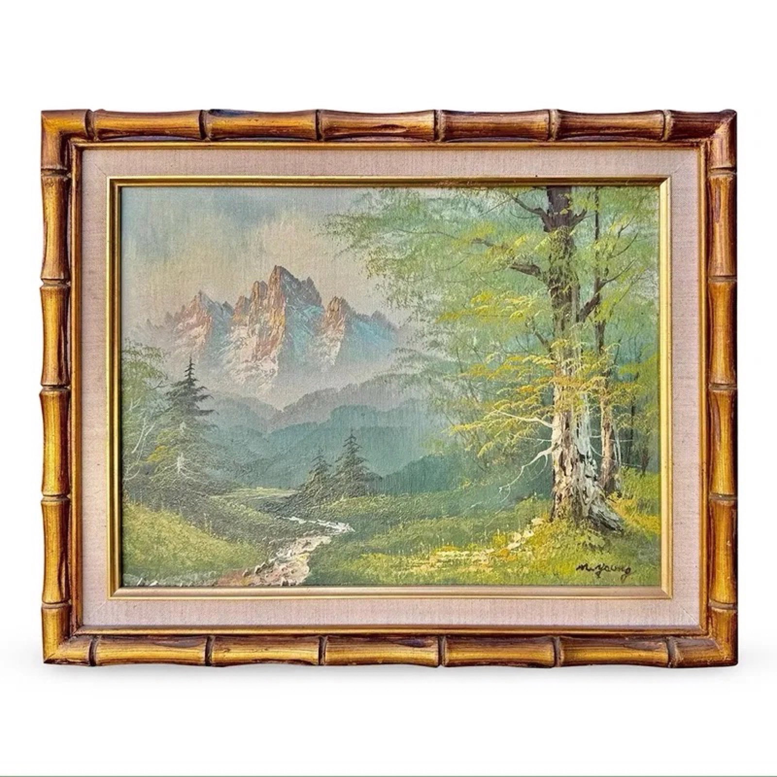 M Young Mountain Landscape Painting: Oil on canvas landscape painting of natural mountains scene. Signed M. Young, matted, and framed in a faux bamboo gilt wood frame. Approx Dimensions: 15.75H x 19.75W x 1.25D inches