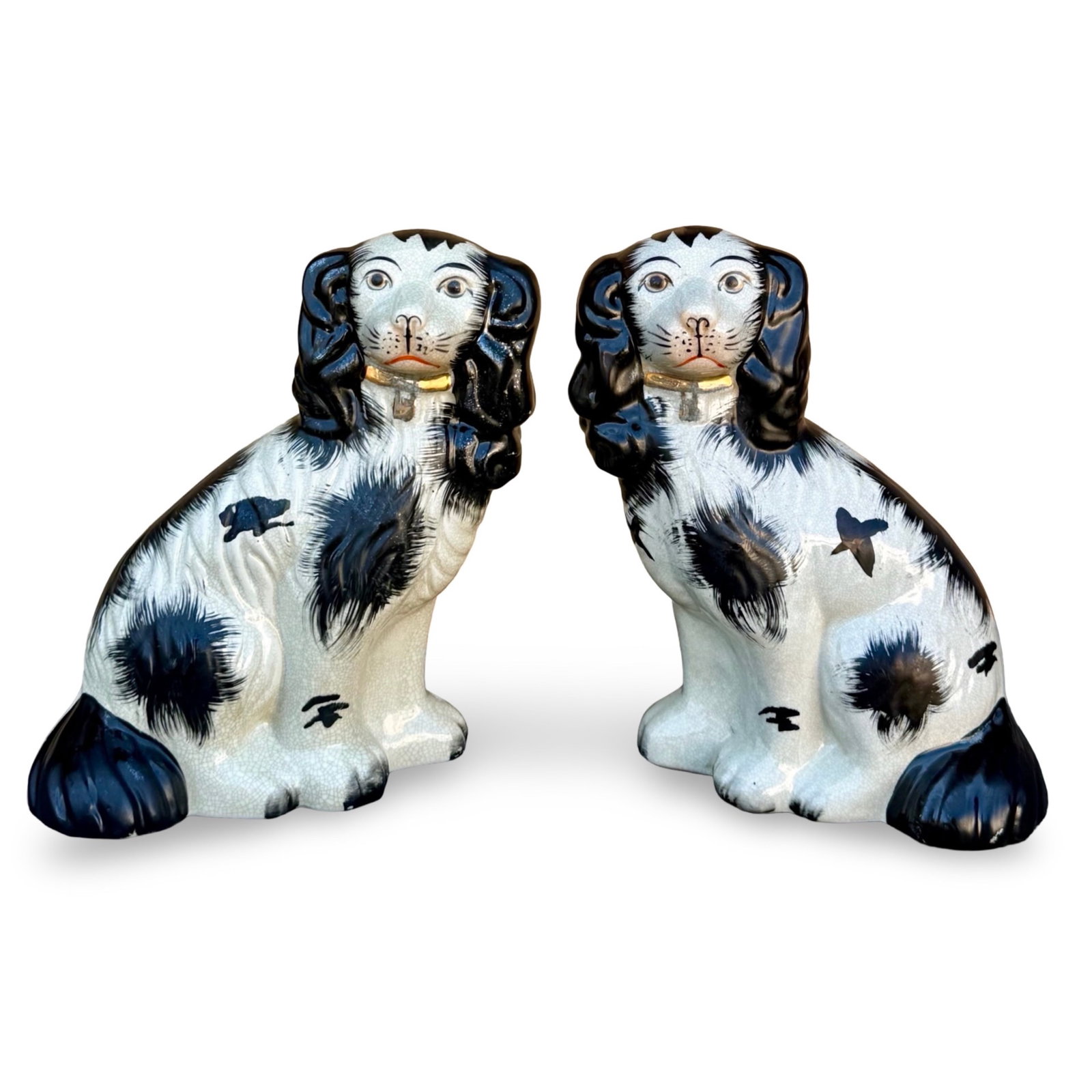 Pair Staffordshire Spaniels Dogs: Pair of antique English Staffordshire pottery Victorian spaniel dog figurines, modeled after Cavalier King Charles Spaniels. Approx. Dimensions: 9.25 H x 7.5 W x 3.75 D inches