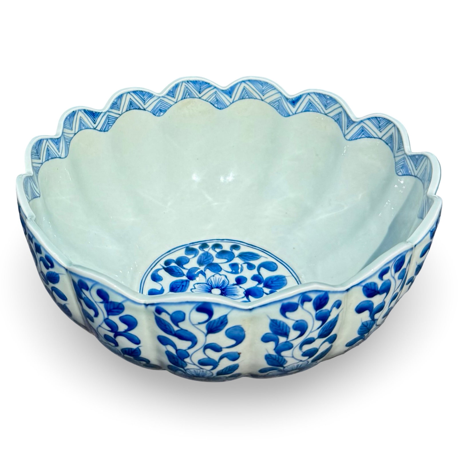 Chinese Blue & White Scalloped Bowl: Chinese blue and white porcelain bowl with a heavily fluted chrysanthemum-form body, scalloped rim, geometric border, and floral decoration in cobalt blue. The underside bears a six-character Kangxi-s