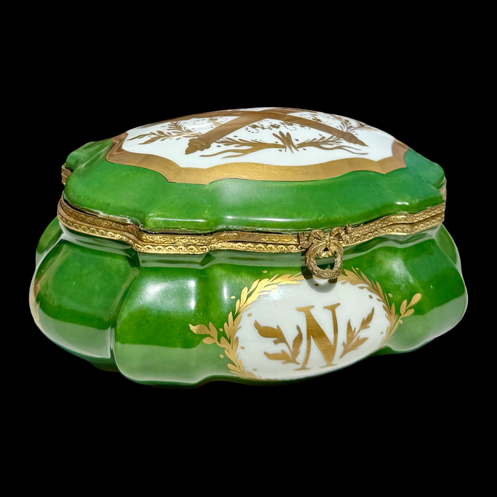 Limoges French Empire Porcelain Casket Box: French Limoges hard-paste porcelain casket box in the Napoleonic Empire Revival style, with an empire-green lobed body, hand-painted gilt decoration, Napoleon “N” monogram, Imperial bees, and 