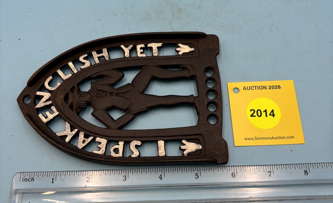J.Z. H. number 19 trivet. Dated 1952 w/ three feet. Reads " I Speak English Yet". (1 of 2)