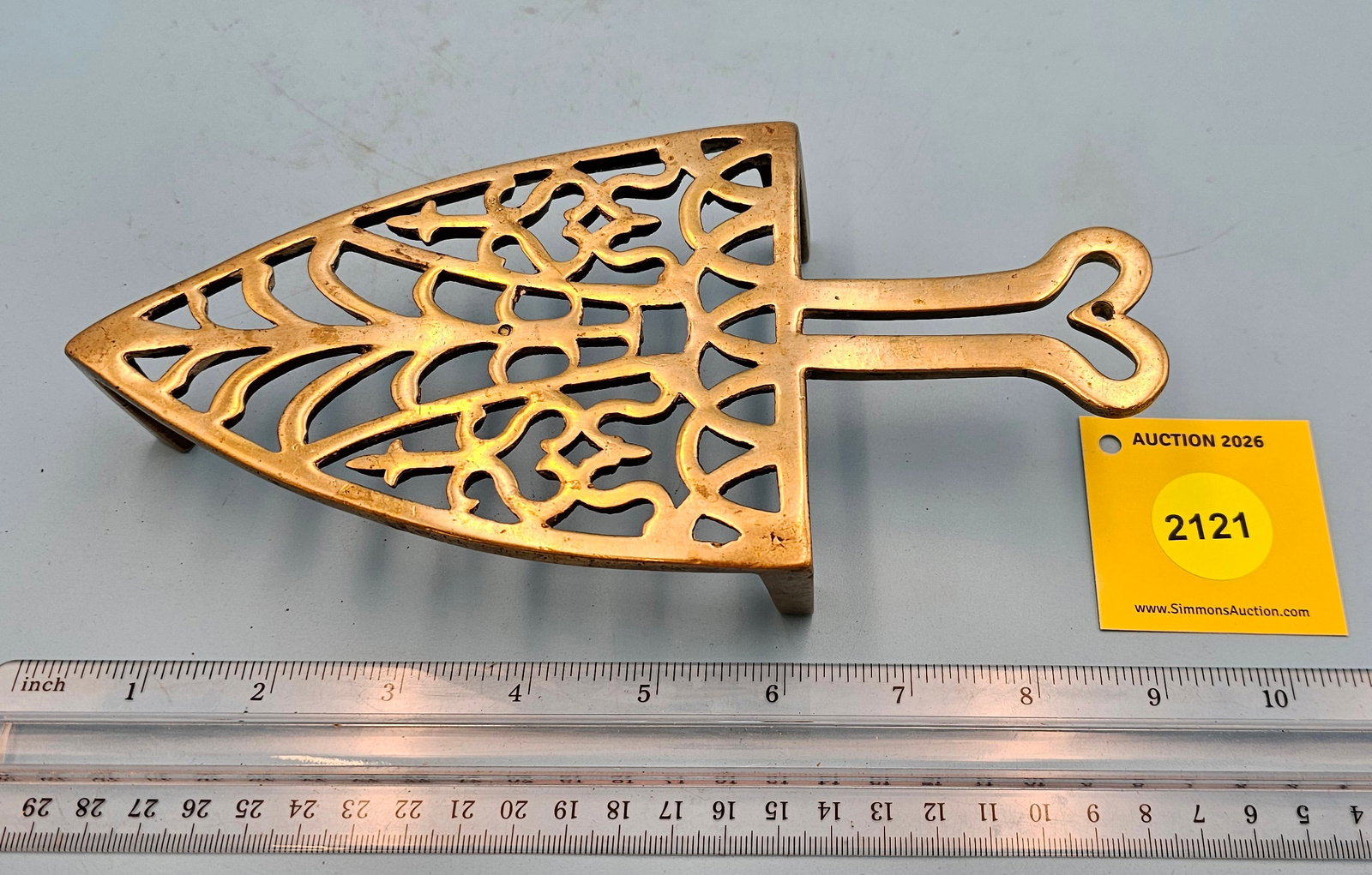 Unmarked Heart & Tulip 8 7/8'' x 4 3/8'' w/ three 1 5/8'' feet trivet. (1 of 2)