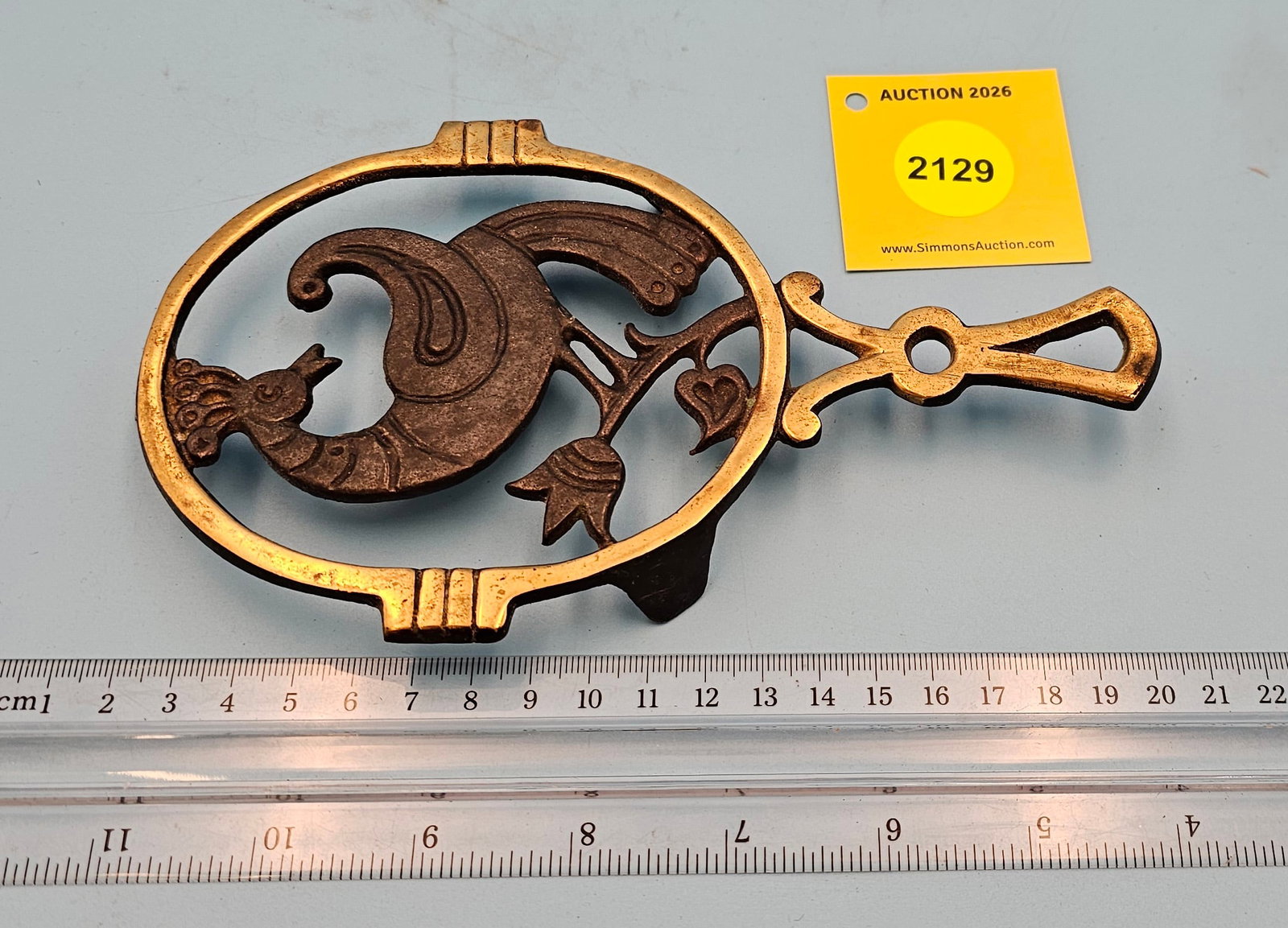Nordia Brass Peacock 7 1/2'' x 4 1/2'' w/ three feet trivet. On reverse marked with Nordia logo (1 of 2)