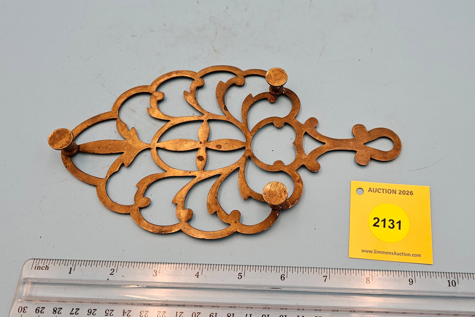 Unsigned India brass open scroll pattern 9'' x 5'' w/ three feet trivet. - 2