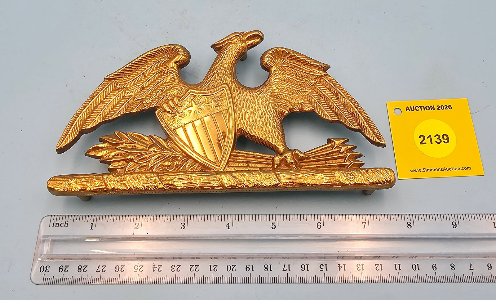 Brass Spread Eagle 4'' x 7 1/2'' w/ three feet trivet. On reverse marked with "Spread Eagle Copyr... (1 of 2)