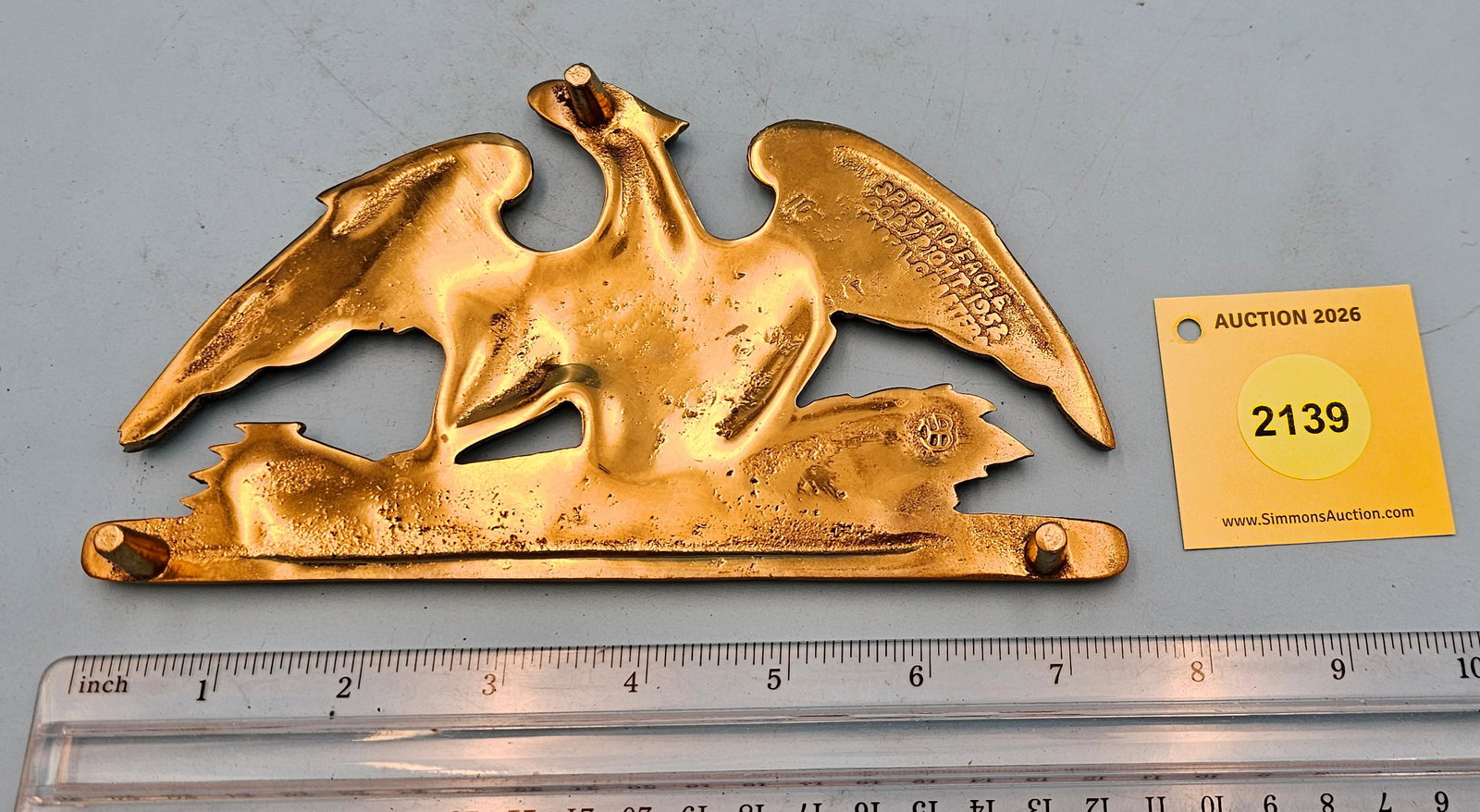 Brass Spread Eagle 4'' x 7 1/2'' w/ three feet trivet. On reverse marked with "Spread Eagle Copyr... - 2