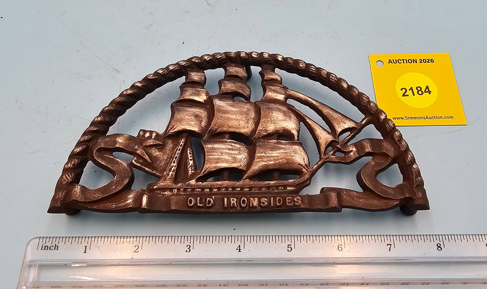 Wilton, semi-circle trivet, sail ship design marked "Old Ironsides": Wilton, semi-circle trivet, sail ship design marked "Old Ironsides"