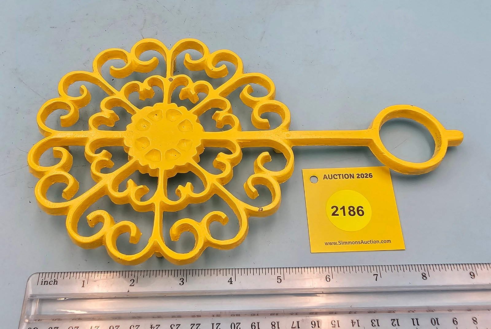 Iron trivet, painted yellow, 9 1/2 x 5 3/4 x 3/4": Iron trivet, painted yellow, 9 1/2 x 5 3/4 x 3/4"