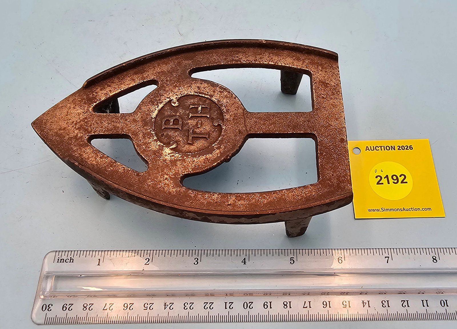 Iron trivet, marked "B T H" on top, 6 1/2 x 4 1/4 x 1 3/4": Iron trivet, marked "B T H" on top, 6 1/2 x 4 1/4 x 1 3/4"