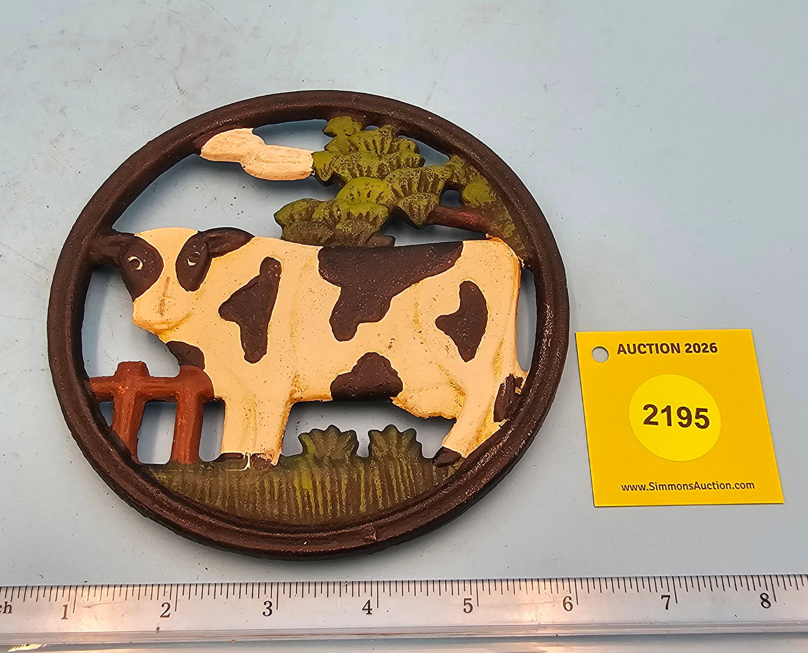 Round cast iron trivet, painted cow design, diameter 5 3/4" height 1/2" (1 of 2)