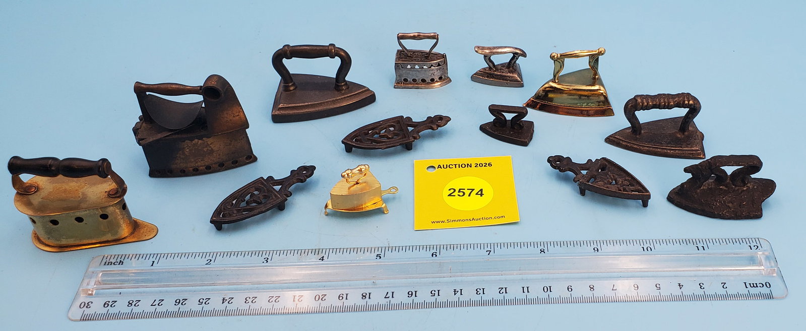 Lot of 14, metal irons (10) and 4 trivets (1 of 2)