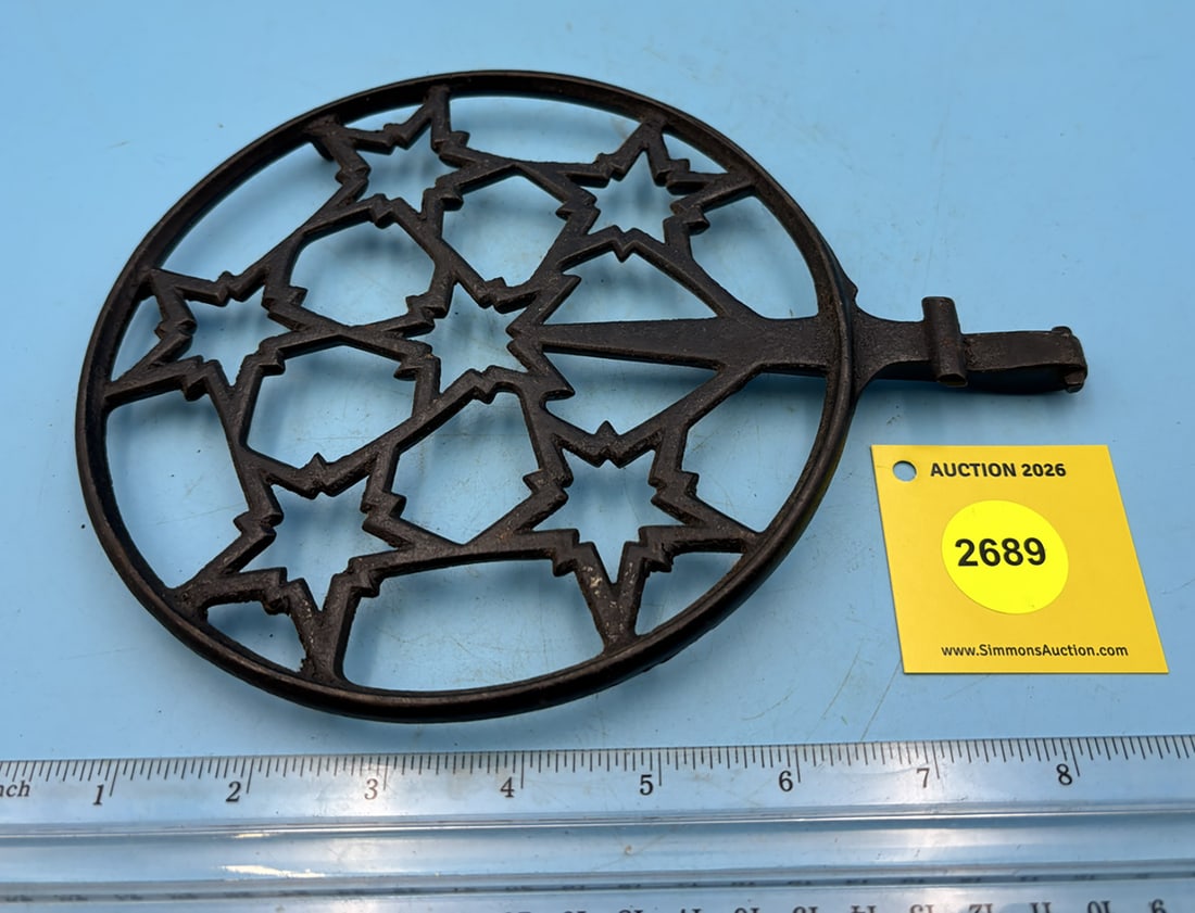 Round trivet to be attached to cookstove, multiple starts w/ handle and two legs: Round trivet to be attached to cookstove, multiple starts w/ handle and two legs