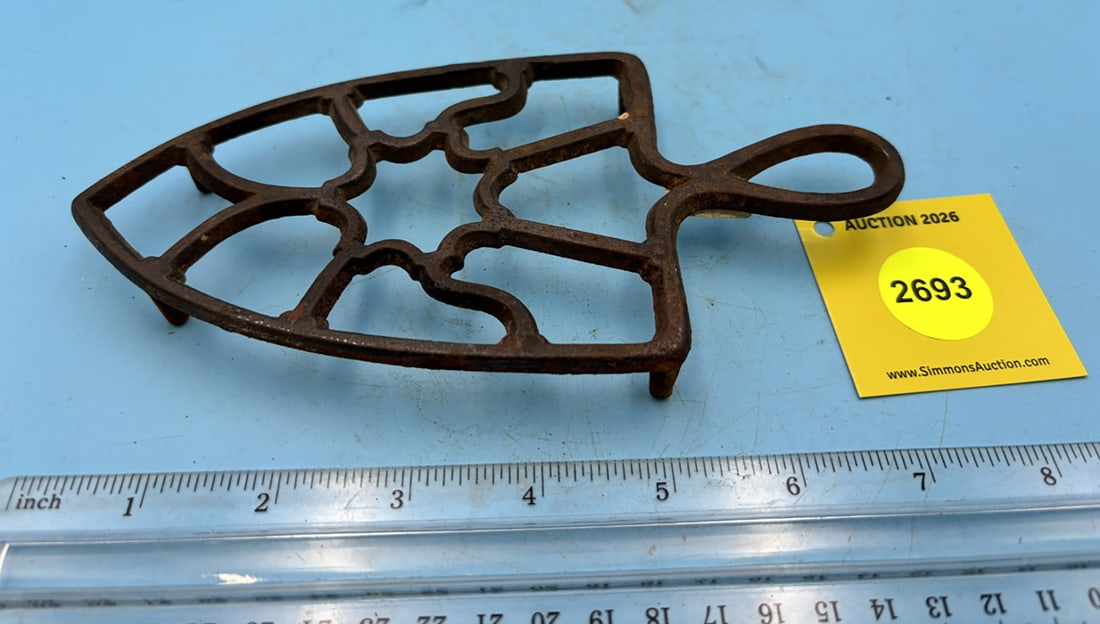 Spade shaped unmakred trivet w/ four legs (1 of 2)