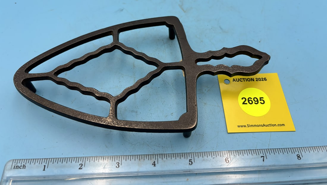 Diamond unmarked shaped trivet w. handle and three legs (1 of 2)