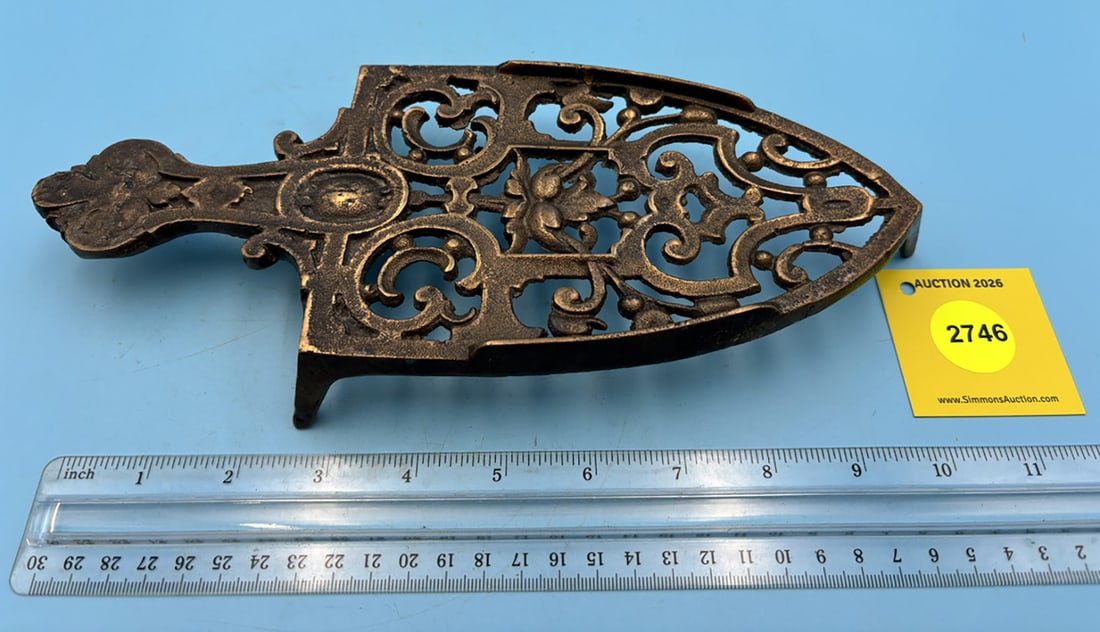 Large floral and scroil pattern trivet w/ handle and three feet: Large floral and scroil pattern trivet w/ handle and three feet