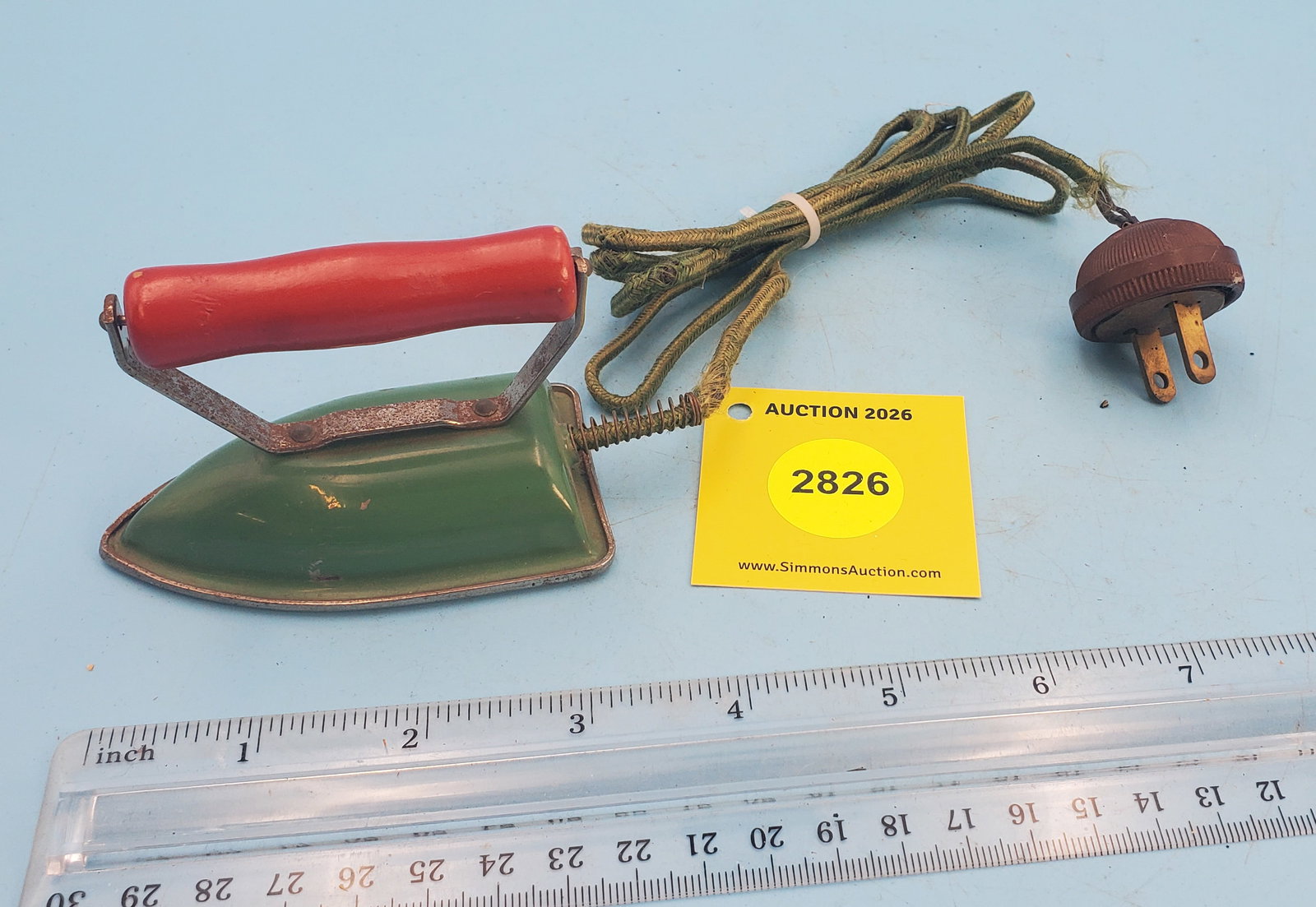 Child's electric iron, green body, red handle: Child's electric iron, green body, red handle