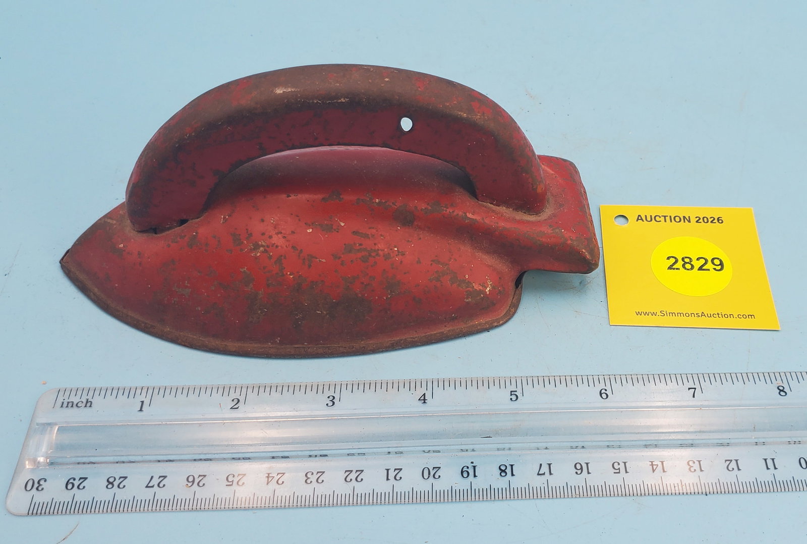 Child's tin streamlined iron painted red: Child's tin streamlined iron painted red