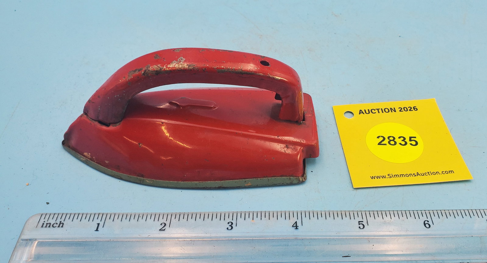 Small red tin child's iron (1 of 2)