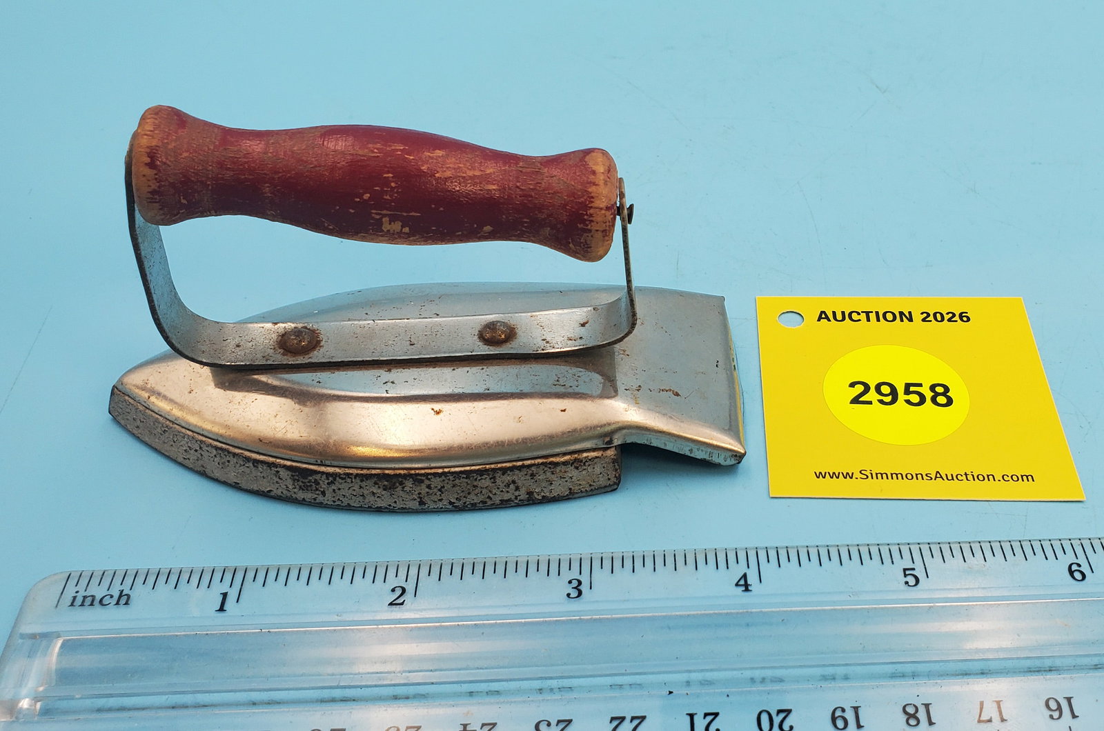 Child's metal streamlined iron, red handle: Child's metal streamlined iron, red handle
