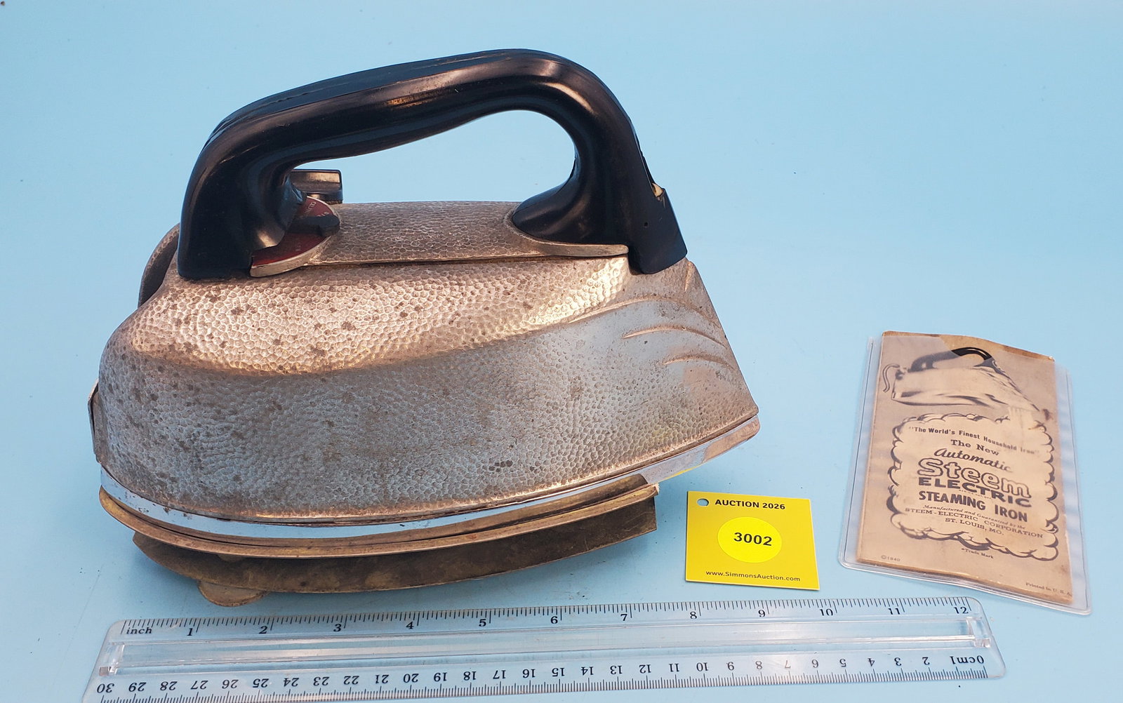 Hammered aluminum steam iron, Steem Electric Corp., St. Louis MO, trivet and instructions (1 of 3)