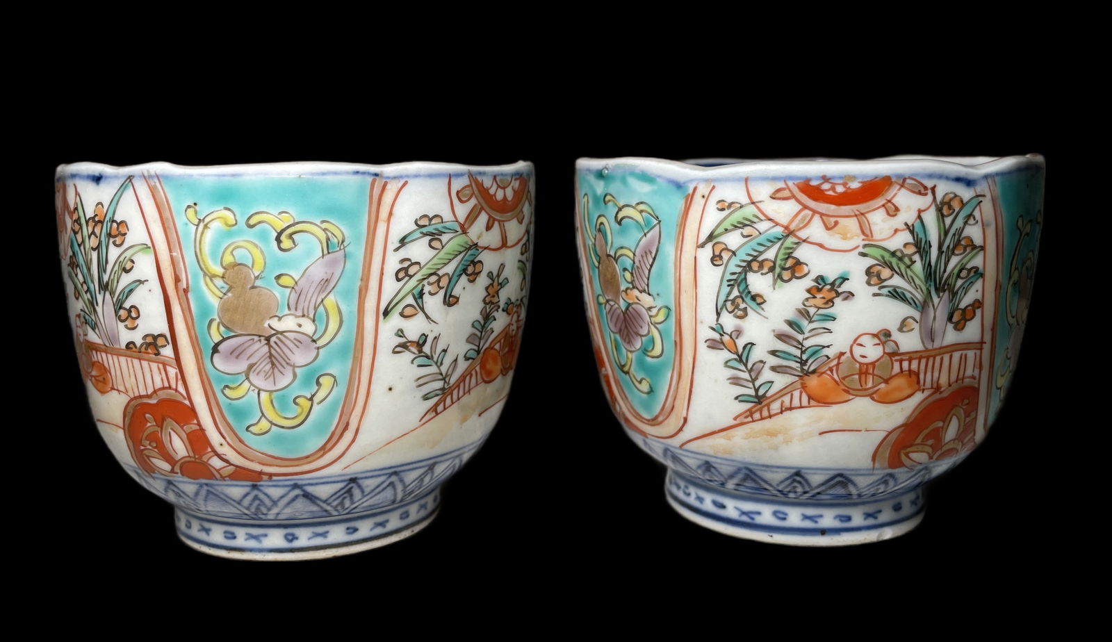 Pair of antique Japanese Imari porcelain teacups: Pair of antique Japanese Imari porcelain teacups with hand-painted floral and geometric motifs in red, blue, and gold.